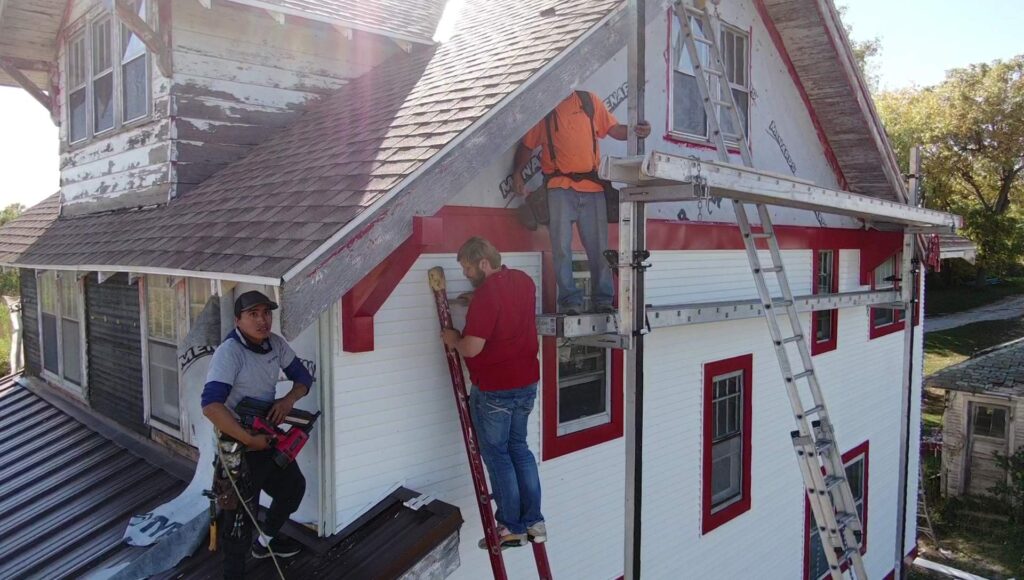 KO Roofing crew completing exterior roofing and siding work on a local project