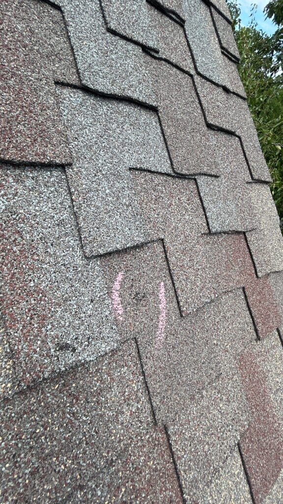 Chalk-marked hail hit on a designer asphalt shingle roof.