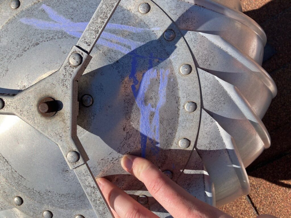 Soft metal turbine vent showing hail impact marks highlighted during inspection.